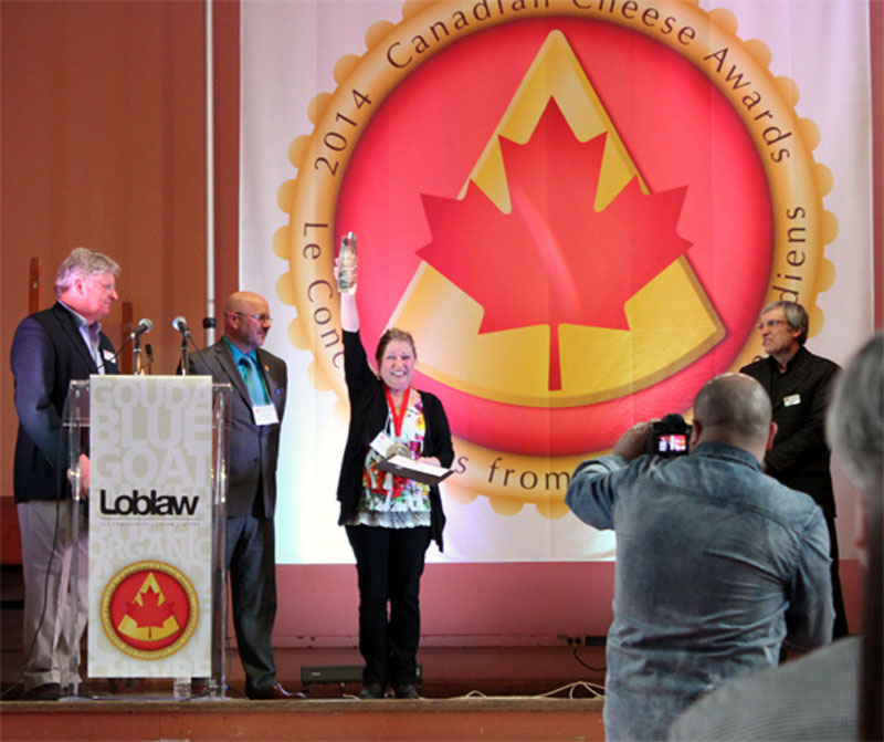 Marie-Claude Harvey, Fromagerie FX Pichet, flanked by Georgs Kolesnikovs, chairman, Canadian Cheese Awards, Gurth Pretty, Loblaw Companies, Marquee Sponsor, and Dr. Arthur Hill, Chief Judge, Canadian Cheese Awards.